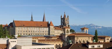 Historic Lausanne rooftops and the cathedral with the Alps in the distance